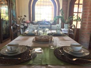 a dining room table with a cake on top of it at B&B civico 7 in Vignola