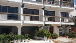 an apartment building with potted plants and balconies at Manoli Apartments in Ayia Napa