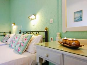 a bedroom with a bed with a bowl on a table at Orion Apartments in Malia