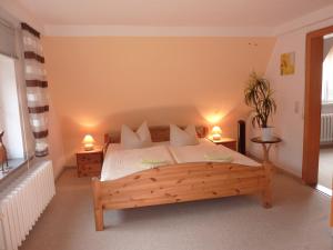 a bedroom with a large wooden bed with two lamps at Falkenstein-Hütten in Bad Schandau