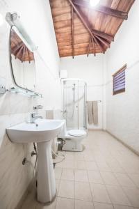 a bathroom with a sink and a toilet at Hotel Yapahuwa Paradise in Yapahuwa