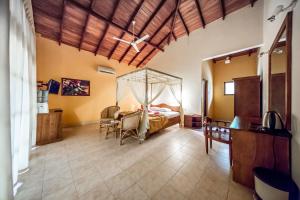 a bedroom with a bed with a mosquito net in it at Hotel Yapahuwa Paradise in Yapahuwa +18 photos