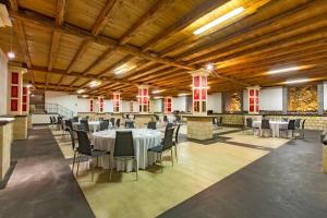 a banquet hall with tables and chairs in a building at Locanda Gulfi in Chiaramonte Gulfi