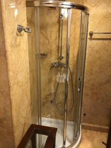 a shower with a glass door in a bathroom at Bellevue Luxury Rooms - San Marco Luxury in Venice