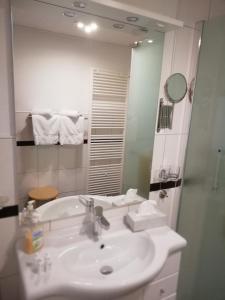 a white bathroom with a sink and a mirror at Panorama-Rheinblick St. Goar in Sankt Goar +23 photos
