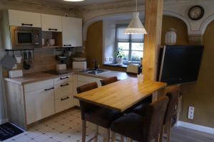 a kitchen with a wooden table and a dining room at Ferienwohnung "Alte Bauernstube" in Meißen