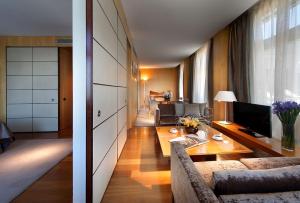 a living room with a couch and a table at Eurostars Grand Marina Hotel GL in Barcelona +161 photos