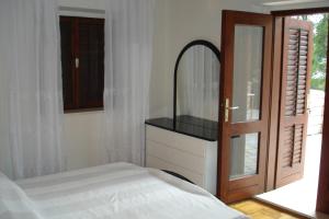 a bedroom with a bed and a mirror and a door at Ancila in Brna