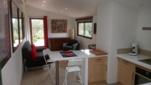 a kitchen with a table and chairs in a room at La Radassière in Cotignac