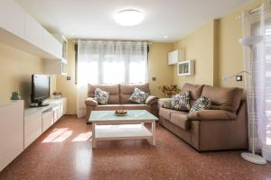 a living room with a couch and a table at ApartUP Mestalla Home in Valencia