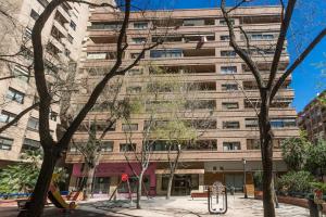 a tall building with a playground in front of it at ApartUP Mestalla Home in Valencia
