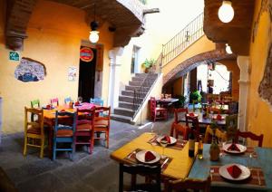 a restaurant with tables and chairs in a building at Hotel Boutique Posada XVII in Puebla