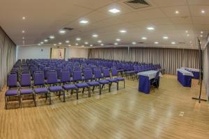 a large room with blue chairs and tables in it at Marante Executive Hotel in Recife +39 photos