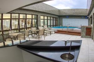 a kitchen with a swimming pool in a building at Marante Executive Hotel in Recife