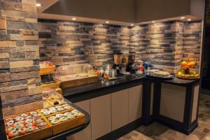 a kitchen with a buffet of food on display at Hotel Pino in Lerici