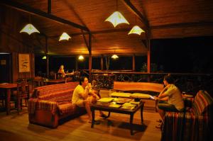 a group of people sitting in a living room at Anaconda Lodge Ecuador in Ahuano