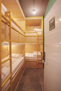 a room with several bunk beds in a room at Konko Hostel Jakarta in Jakarta