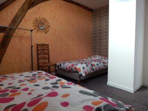 Postel nebo postele na pokoji v ubytování Gite chez Marcel et Béa