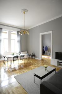 a white living room with a table and chairs at Budapest Danube Panorama Apartment in Budapest