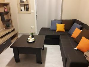 a living room with a couch and a coffee table at Jz boutique apartments in Rhodes Town