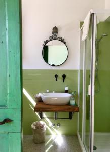 a bathroom with a sink and a mirror at La Goiaba B&B in Senigallia