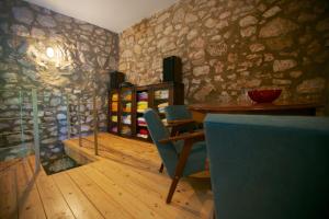 a dining room with a table and chairs and stone walls at Abeona Mediterranean Villa in Drivenik