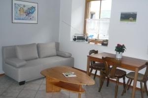 a living room with a couch and a table at Ferienwohnung Hammelburg in Hammelburg