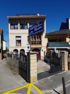 a building with a sign on the front of it at Hostal la Picota in Liencres