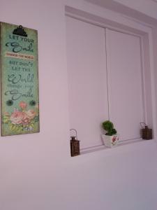 a window sill with a sign and a plant on it at The Sweetest Acropolis Flat in Athens