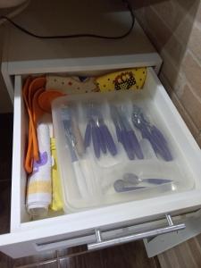 a drawer filled with utensils in a cabinet at Chales Alpes Germanicos in Monte Verde