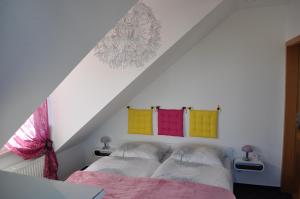 a bedroom with two beds with colorful towels on the wall at ****Fewo "Alltag...ADE'" in Dippoldiswalde