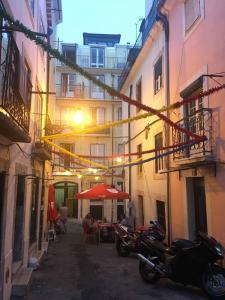 リスボンにあるNew Luxury Apartment - Lisbon Centerの建物の並ぶ路地に停められた一団の二輪車