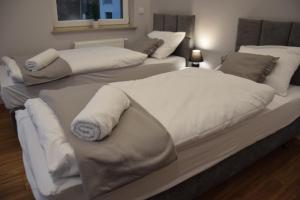 two beds with towels on them in a room at Apartament Pod Gondolą "9" in Świeradów-Zdrój