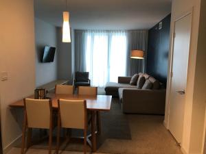 uma sala de estar com uma mesa e um sofá em Beach Walk Resort De Lux Apartment em Hallandale Beach