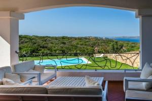 a living room with a large window with a view of a pool at Villa Smeralda in Palau