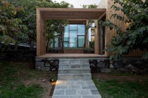 a house with a porch and a stone walkway at Quinta de Santa Clara in Ponta Delgada