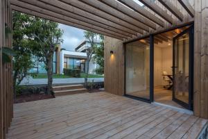 an external view of a wooden deck with sliding glass doors at Quinta de Santa Clara in Ponta Delgada