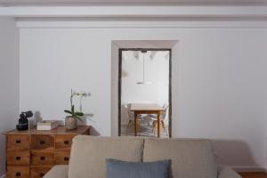 a living room with a couch and a mirror at Quinta de Santa Clara in Ponta Delgada