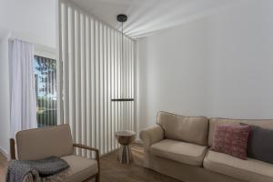 a living room with a couch and a chair at Quinta de Santa Clara in Ponta Delgada
