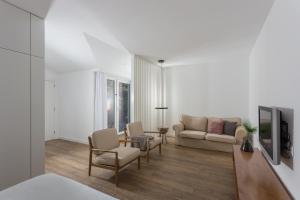 a living room with a couch and a table at Quinta de Santa Clara in Ponta Delgada