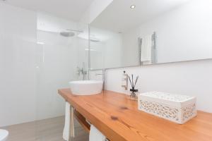 a bathroom with a sink on a wooden counter at Quinta de Santa Clara in Ponta Delgada