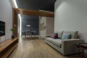 a living room with a couch and a table at Quinta de Santa Clara in Ponta Delgada