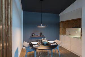 a dining room with a table and two chairs at Quinta de Santa Clara in Ponta Delgada