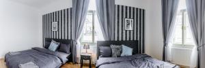 a bedroom with a bed and two nightstands at Top Wenceslas Square Apartment in Prague
