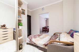 a small bedroom with a bed and a mirror at Lviv Land in Lviv