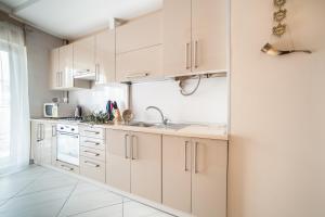 a kitchen with white cabinets and a sink at Lviv Land in Lviv