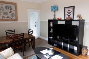 a living room with a television and a table at Sauerdough Lodging in Seward