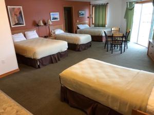 A bed or beds in a room at Longliner Lodge and Suites