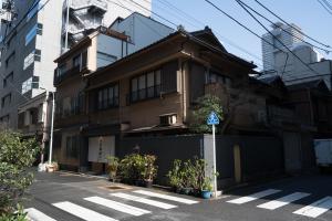 a building on a street with a cross walk at Ito Ryokan in Tokyo