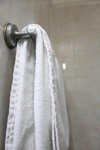 a towel hanging on a shower door in a bathroom at Mega Bintang Sweet Hotel 2 in Cepu